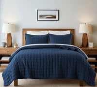 Navy quilt with geometric stitching and two matching pillow shams