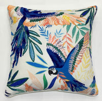 Two blue parrots in flight embroidered on a tropical leaf throw pillow