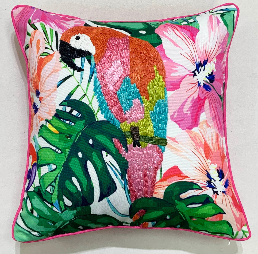 Tropical floral throw pillow with sunset-colored petals and corner tassels